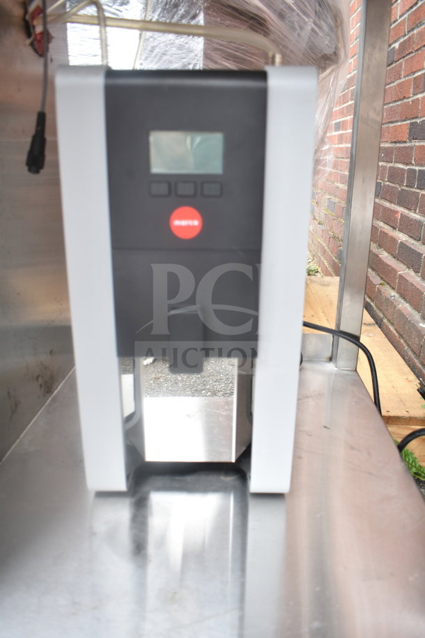 Stainless steel table with sink bay and Marco 10018805BX beverage system; features a digital display and red "Marco" label.