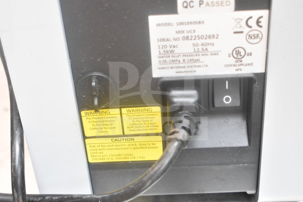 "Marco 10018805BX Beverage System label; model, serial number, specs, and safety warnings visible on the unit."