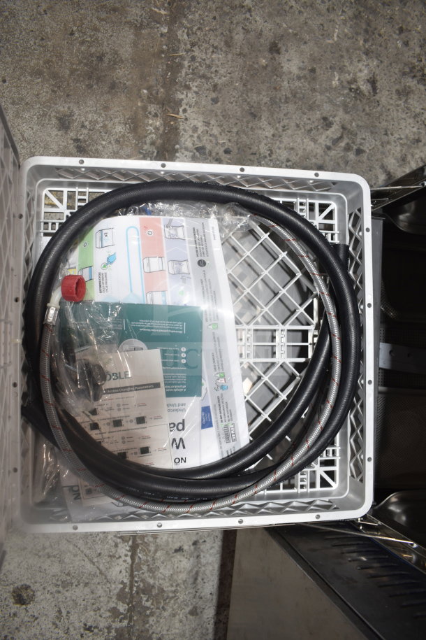 Brand new Noble 495LTUC24 commercial dishwasher, visible hoses, manuals; low-temperature undercounter, 120 volts, 1 phase.