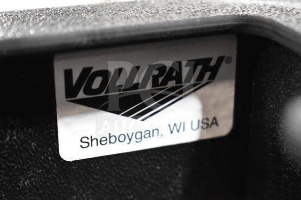 Vollrath black thermoplastic flush mount vertical 4-slot lid holder with straw slot, label reads "Sheboygan, WI USA."