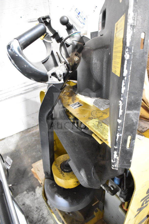 Yale E Industrial Walkie Stacker, walk-behind type, sturdy handle, visible wear, yellow and black, safety markings shown.