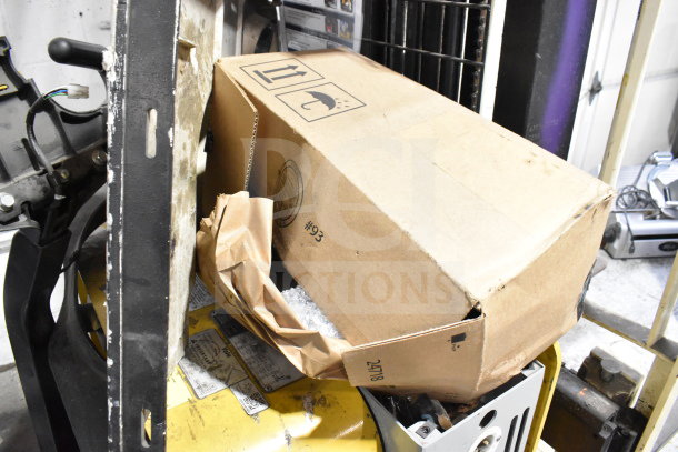 Yale E Industrial Walkie Stacker with control handle, cardboard box on fork. Used condition, visible control panel.