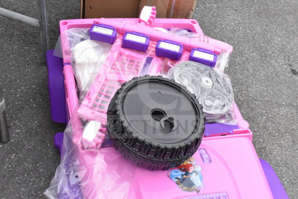 Pink and Purple Princess Ride-On Vehicle parts, unassembled, new. Features Disney princess design and plastic wheels.