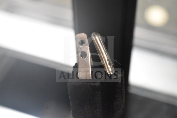 Close-up of the plug for Avantco 193BCFD72B bakery display case, showing standard prongs for 110-120 volts.
