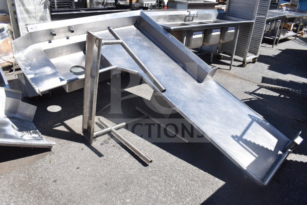 Commercial L-shaped dish table, right-side dirty area, stainless steel, slightly worn, with integrated sink and draining area.
