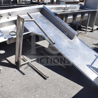 Commercial L-shaped dish table, right-side dirty area, stainless steel, slightly worn, with integrated sink and draining area.