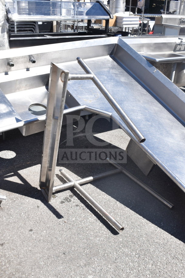 Stainless steel L-shaped dish table, dirty side right, commercial use, used condition, visible fittings and leg supports.
