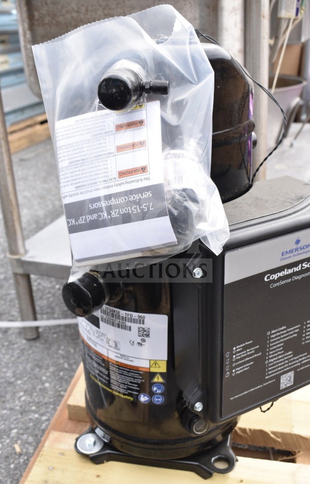 Brand new Emerson ZF34K5E-TFD-960 compressor with scratch and dent. Features visible labels and tags detailing specifications.