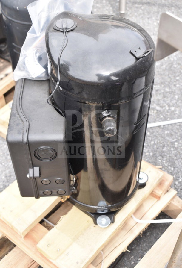 Brand new Emerson ZF34K5E-TFD-960 compressor; black finish; minor scratches; mounted on a wooden pallet.