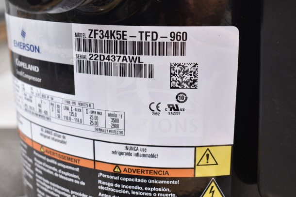 Brand new Emerson ZF34K5E-TFD-960 compressor; visible model and serial number labels; scratch and dent condition.
