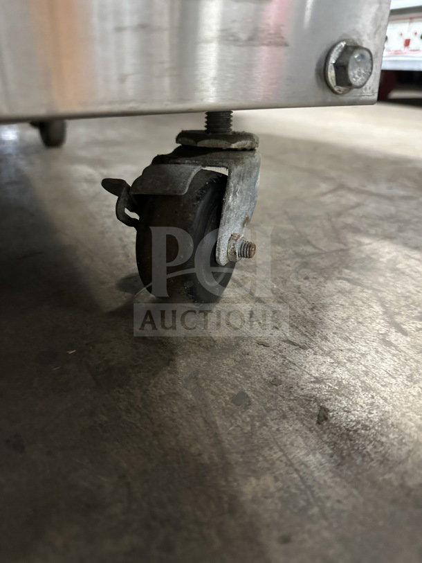 Winston Industries Cvap CAC507GR stainless steel undercounter oven, 208V, on casters, shown close-up of a caster wheel.