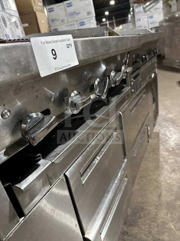 Commercial stainless steel 4-drawer refrigerated chef base, gas radiant charbroiler, and griddle on casters. Visible auction tag.
