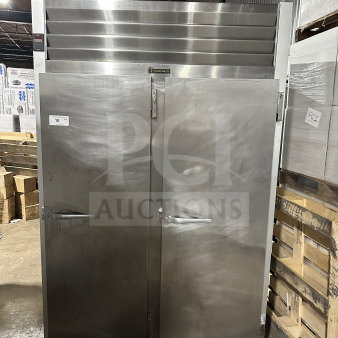 Traulsen G22012 commercial stainless steel 2-door reach-in freezer, poly coated wired rack, good condition, on casters.