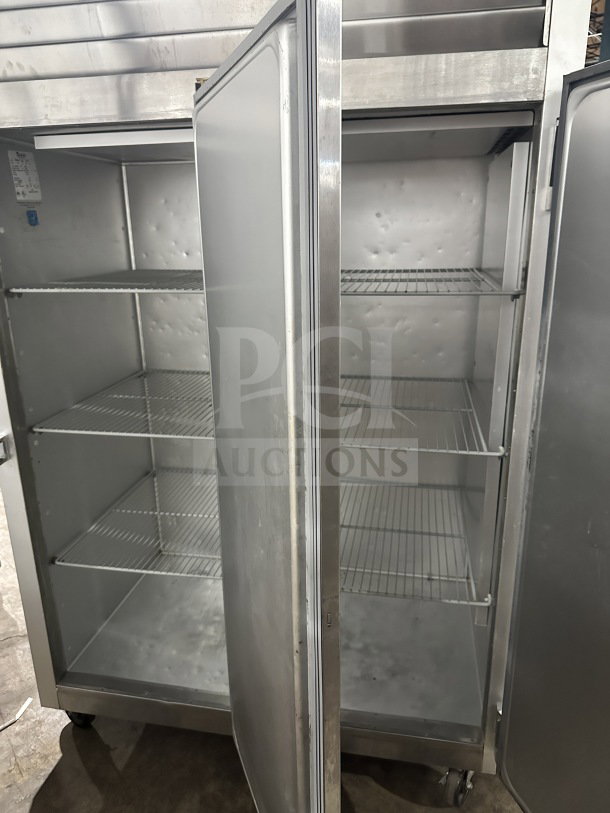 Traulsen commercial stainless steel 2-door reach-in freezer, Model G22012, with poly-coated racks, on casters, 115V, 1 phase.