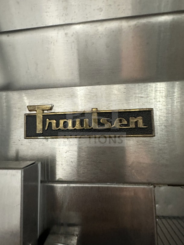 Traulsen G22012 stainless steel 2-door reach-in freezer, poly coated racks, on casters, model label visible.