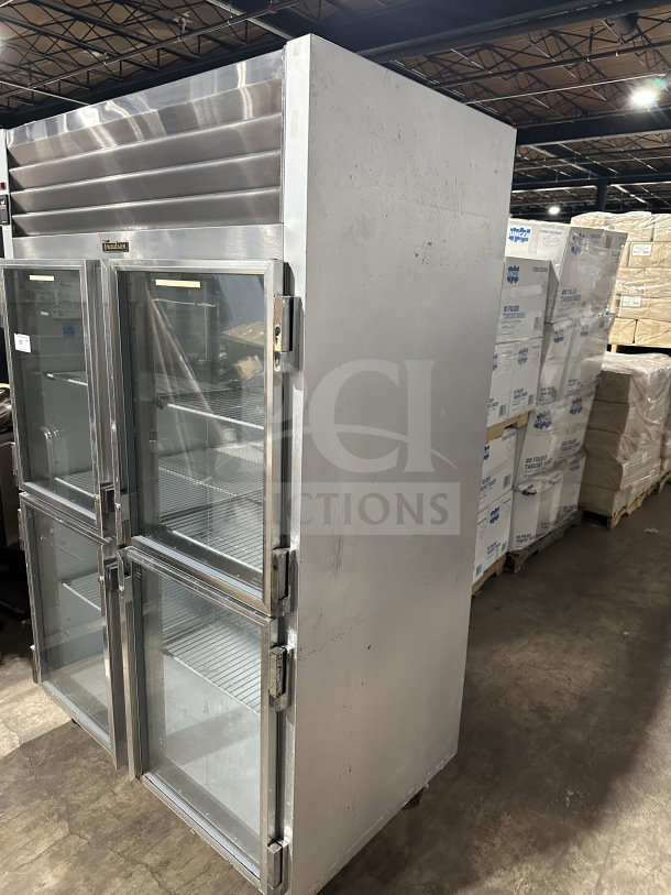 Traulsen G21000 commercial stainless steel refrigerator, 2-section, 4 half-glass doors, poly-coated rack, on casters.