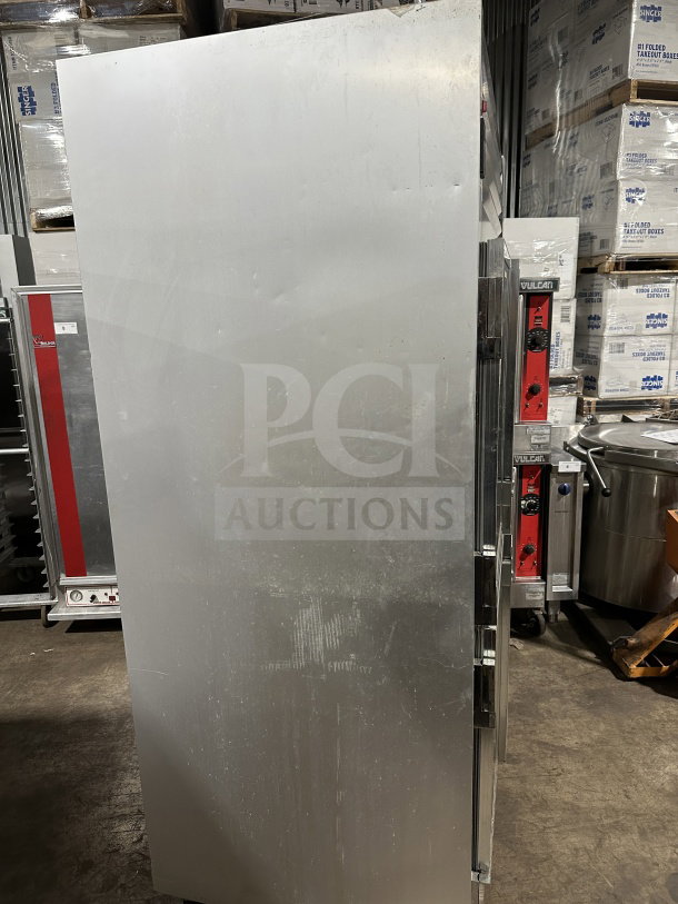 Traulsen G21000 commercial stainless steel refrigerator, electric, 2-section, 4 half-glass doors, on casters, with poly-coated wire rack.