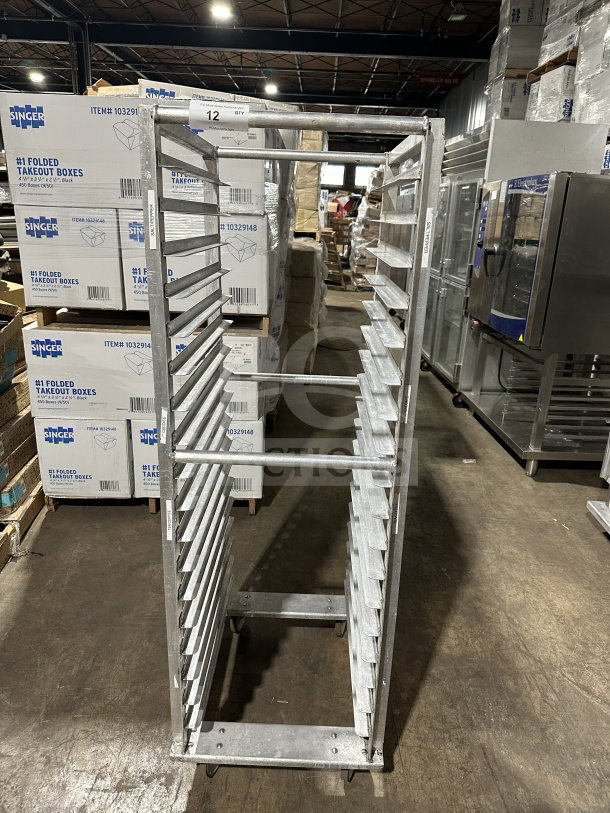 Commercial stainless steel heavy-duty welded transport pan rack on casters, good condition, multiple slots for sheet pans.