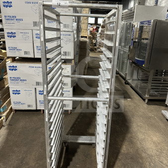 Commercial stainless steel heavy-duty welded transport pan rack on casters, good condition, multiple slots for sheet pans.