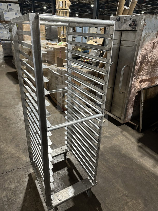 Commercial stainless steel welded transport pan rack with multiple shelves, on casters, excellent condition.