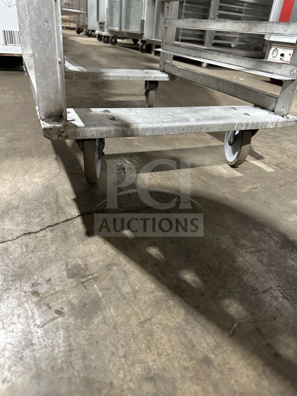 Commercial stainless steel welded pan rack on casters, robust build, designed for transporting sheet/bun pans. Used condition.