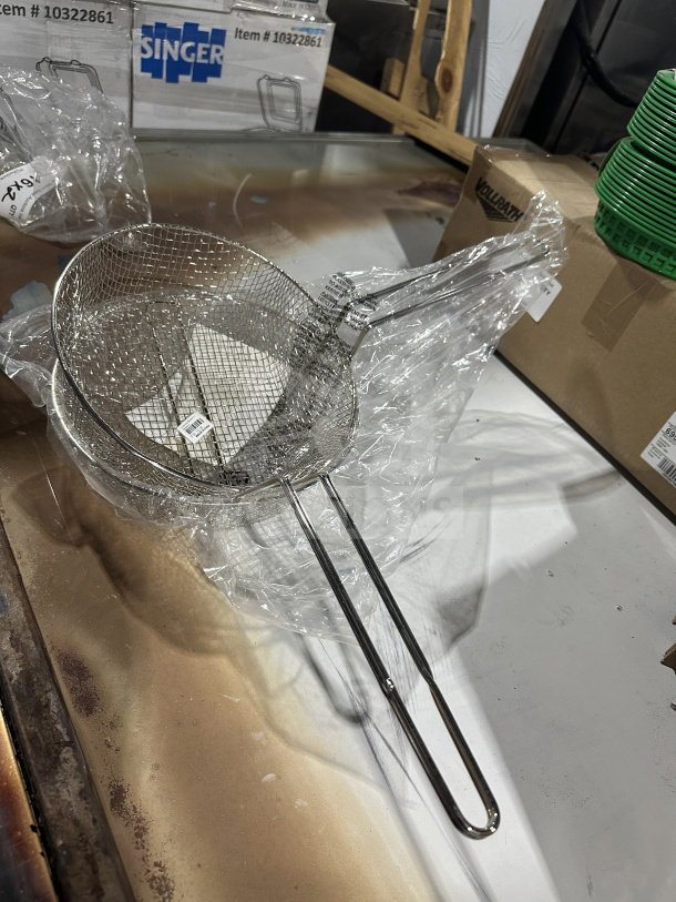 Brand new Winco 10'' commercial fry basket, model FB10M, medium-mesh, heavy-duty, in original packaging.