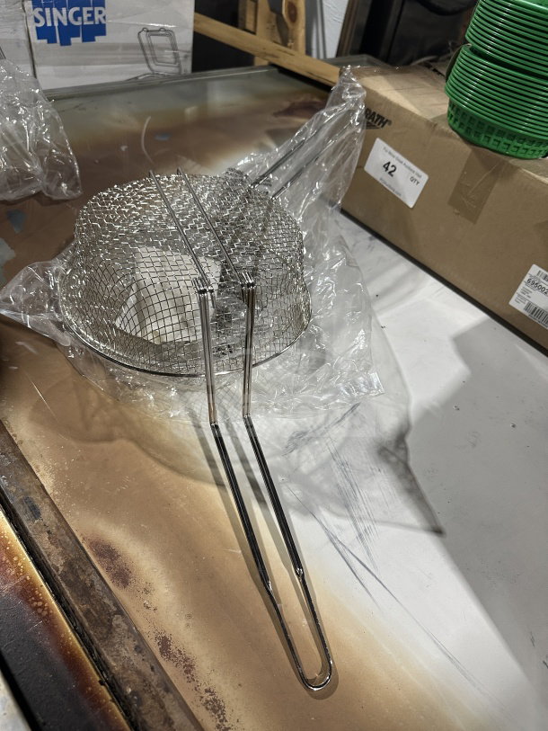 Brand new Winco 10" commercial heavy-duty medium-mesh round fry basket, model FB10M, in pristine condition.