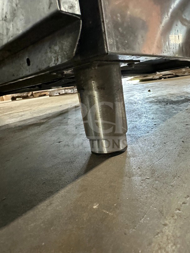 Stainless steel leg of Amercian Panel Hurri Blast Series commercial blast chiller, Model AP12BCF1103, on concrete floor.