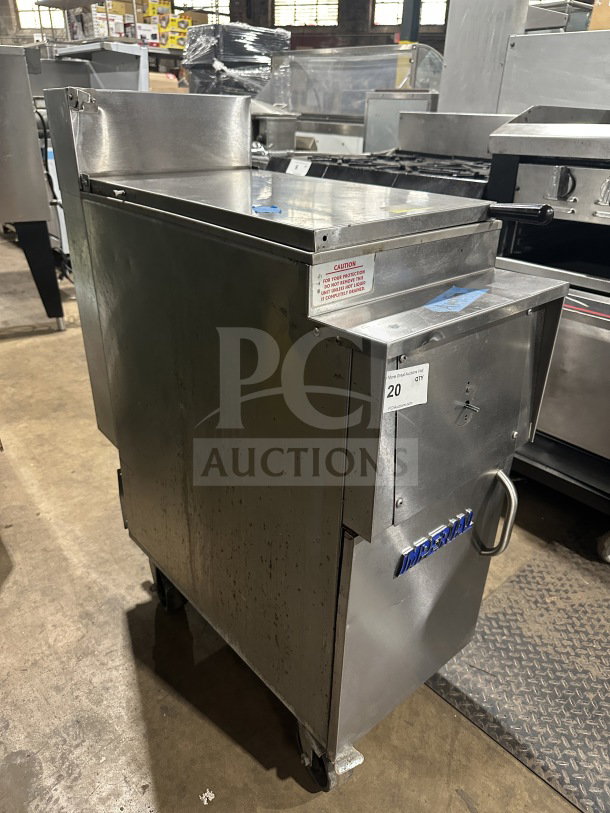 Imperial commercial stainless steel natural gas fryer with back splash, on casters. Used condition with visible markings.