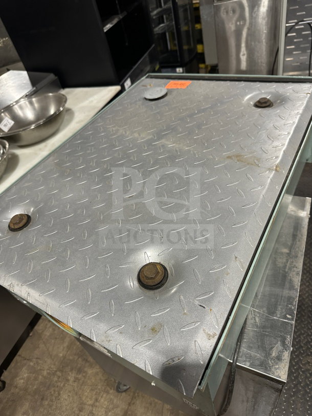 Mifab MIGL20 grease interceptor on custom stainless steel cart with casters, features diamond plate cover and visible wear.