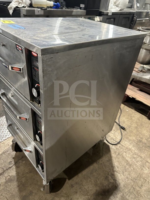 Hatco HDW3N stainless steel 3-drawer warmer, electric-powered, freestanding, on casters, good condition, model SN: 8736212133.