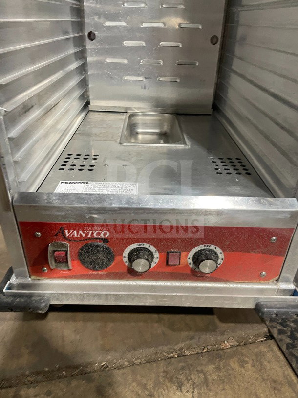 Avantco 177HPU1836 stainless steel heated cabinet; single glass door, built-in pan slides, on casters; electric controls visible.