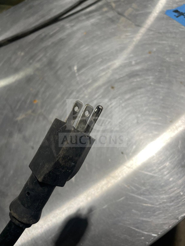 Close-up of a 120V power plug for an Avantco Model 177HPU1836 stainless steel heated cabinet.