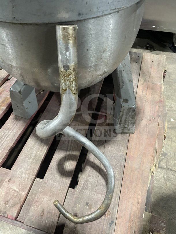 Welbilt Varimixer commercial planetary mixer with dough hook and stainless steel bowl, showing wear on the attachment.