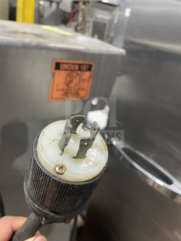 Welbilt Varimixer commercial planetary mixer with dough hook and stainless steel bowl, shown with power plug and "UNIVEX NSP" label.