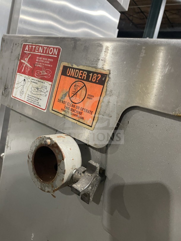 Welbilt Varimixer commercial planetary mixer, floor style, with dough hook and stainless steel mixing bowl. Warning labels visible.