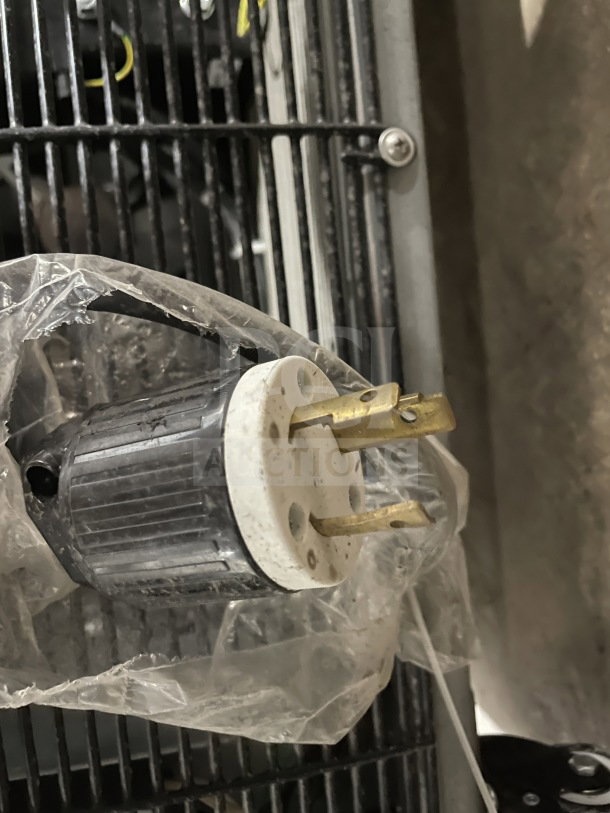 Close-up of Avantco 193VOA48B plug and grill. The plug is wrapped in plastic. Condition appears new. Safety grounding pin visible.
