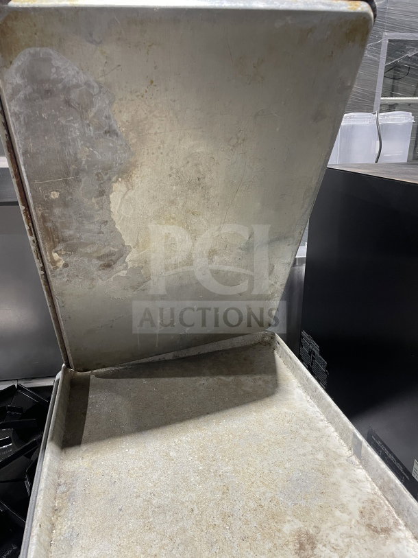 Commercial aluminum full-size baking sheet pan, well-used condition, subtle patina, ideal for high-volume baking.