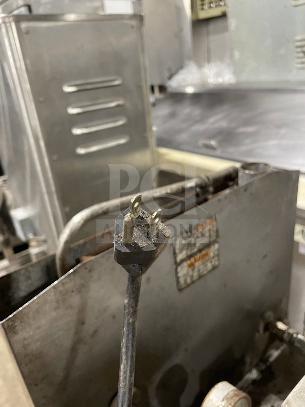 Henny Penny 600RB gas pressure fryer, stainless steel, on casters, condition shows signs of use, visible power cord and label.