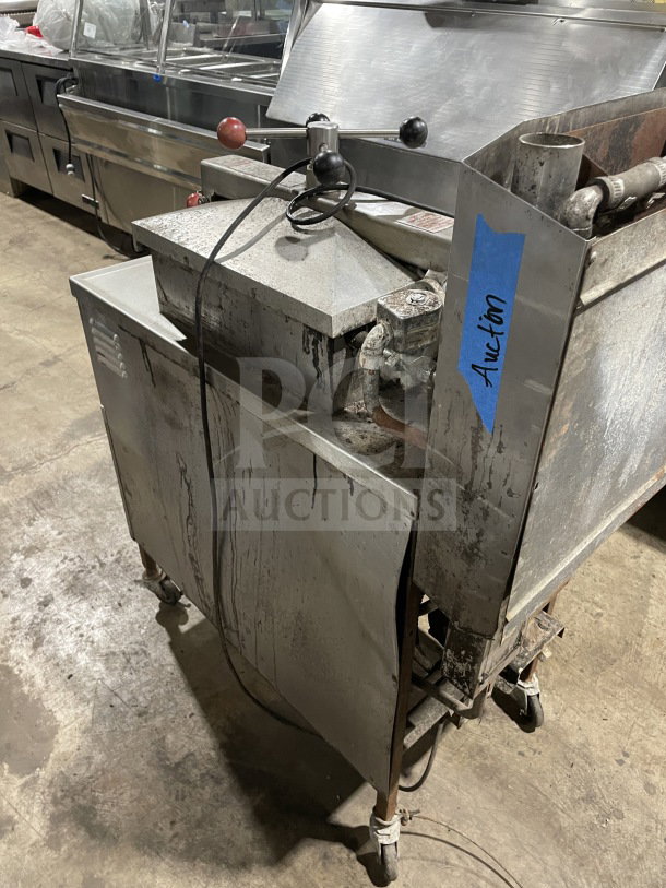 Henny Penny 600RB commercial stainless steel gas pressure fryer on casters, showing wear, with visible auction label.