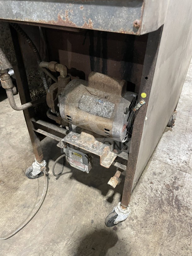 Henny Penny 600RB gas pressure fryer, stainless steel, floor model on casters, shows visible wear, Model: 600RB SN: EA023JA.