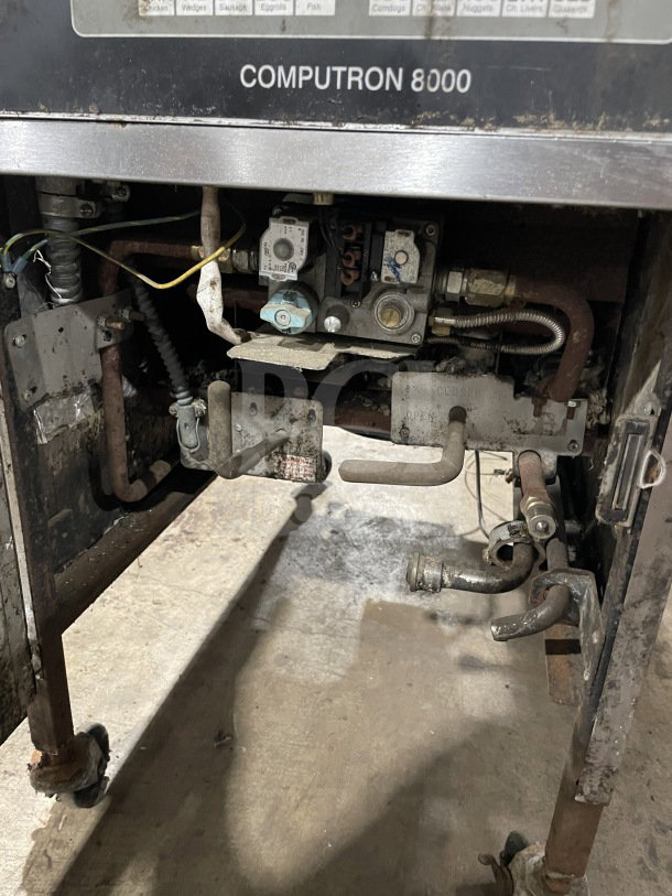 Henny Penny 600RB gas pressure fryer, stainless steel, floor model, visible Computron 8000 label, on casters, used condition.