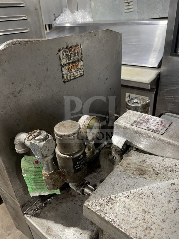 Henny Penny 600RB commercial stainless steel gas pressure fryer, used condition, with visible warnings and casters.