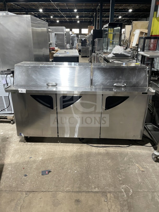 Turbo Air TST-72SD-30-N 3-door stainless prep table; refrigerated, bain marie style, chrome rack, cutting board, casters.