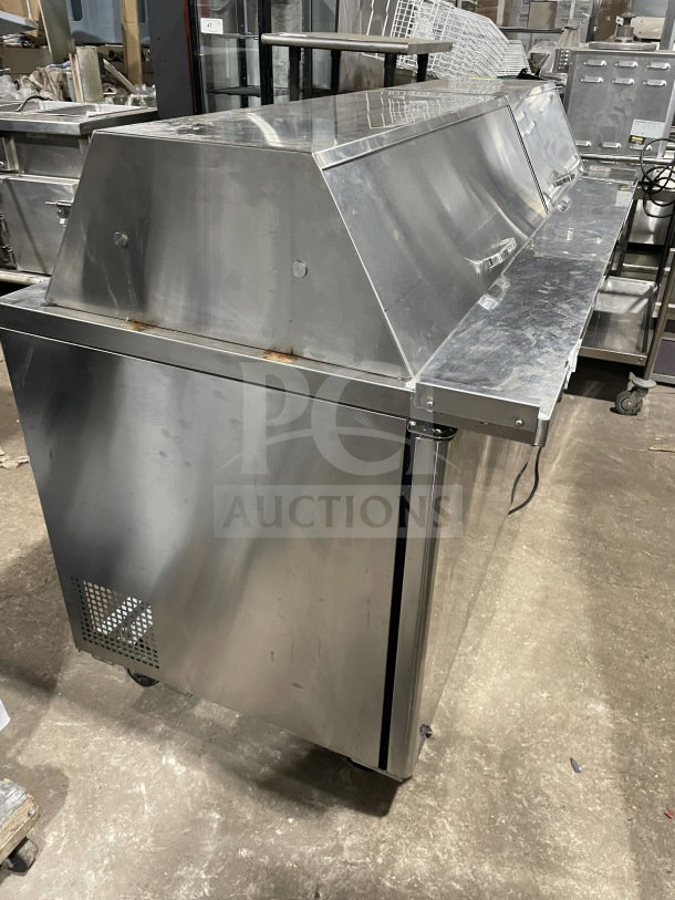 Turbo Air TST-72SD-30-N stainless steel 3-door refrigerated prep table, chrome rack, cutting board, on casters, 115V.