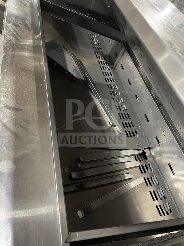 Turbo Air TST72SD30N 3-Door Refrigerated Prep Table, stainless steel, chrome rack, cutting board, on casters, new condition.