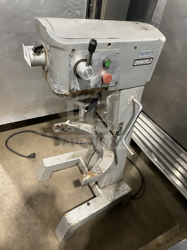 Uniworld commercial stainless steel planetary mixer, used condition, visible control knobs, and manufacturer's label.
