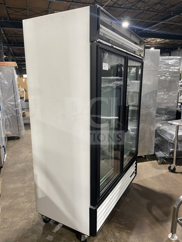 True GDM-49 commercial double glass door refrigerator with poly coated wire rack, on casters, 115V, 1-phase, minor wear.