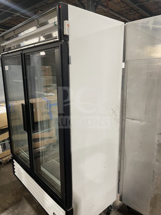 True GDM-49 double glass door merchandiser refrigerator, poly coated wire racks, 115V, 1 phase, on casters.