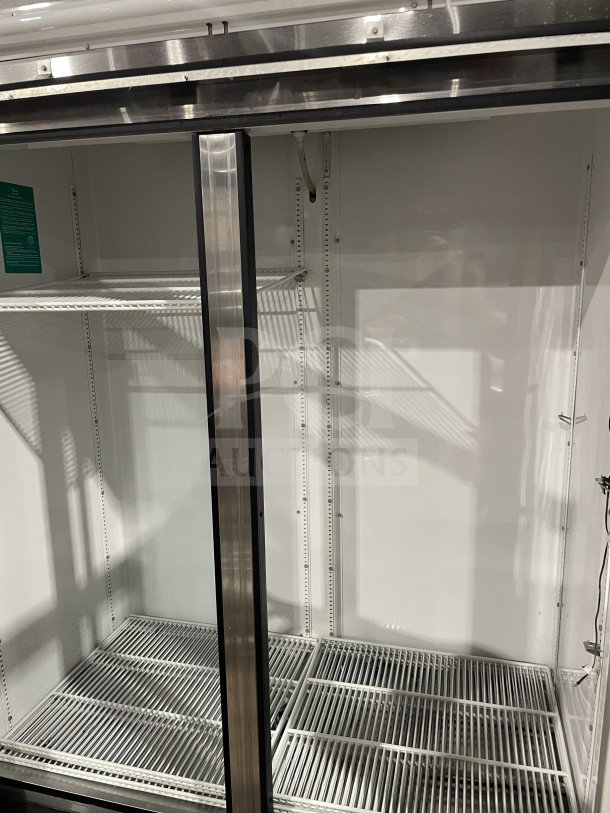 True GDM-49 commercial refrigerator, double glass swing doors, poly coated wire racks, stainless steel finish, on casters.
